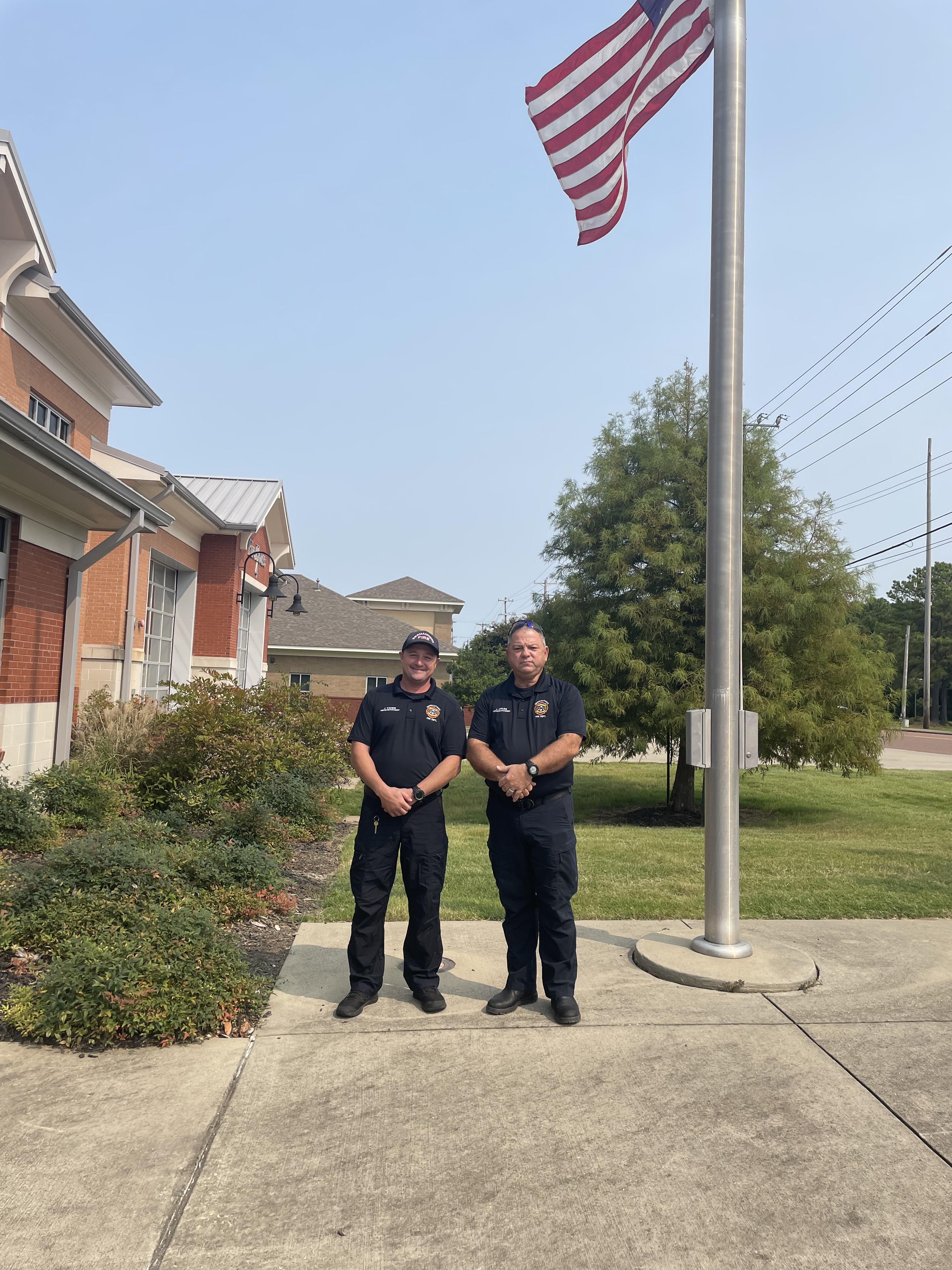 officers in front of flag